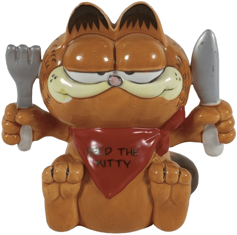 A coin bank of Garfield sitting with a fork and knife raised. He is wearing a red bandana that reads 'Feed the kitty.'